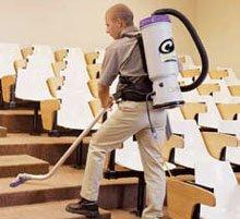 Man carrying backpack vacuum cleaning