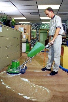 A Man cleaning a carpet