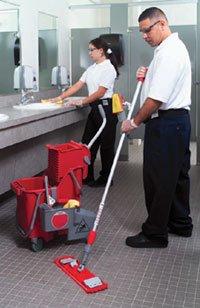 A Man and a woman cleaning inside the restroom
